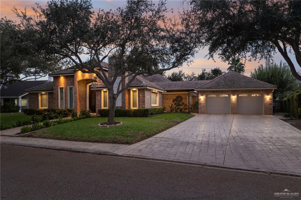809 Rio Grande Drive Mission, TX 78572 - Photo 2 of 45 a front view of a house with a garden and tree