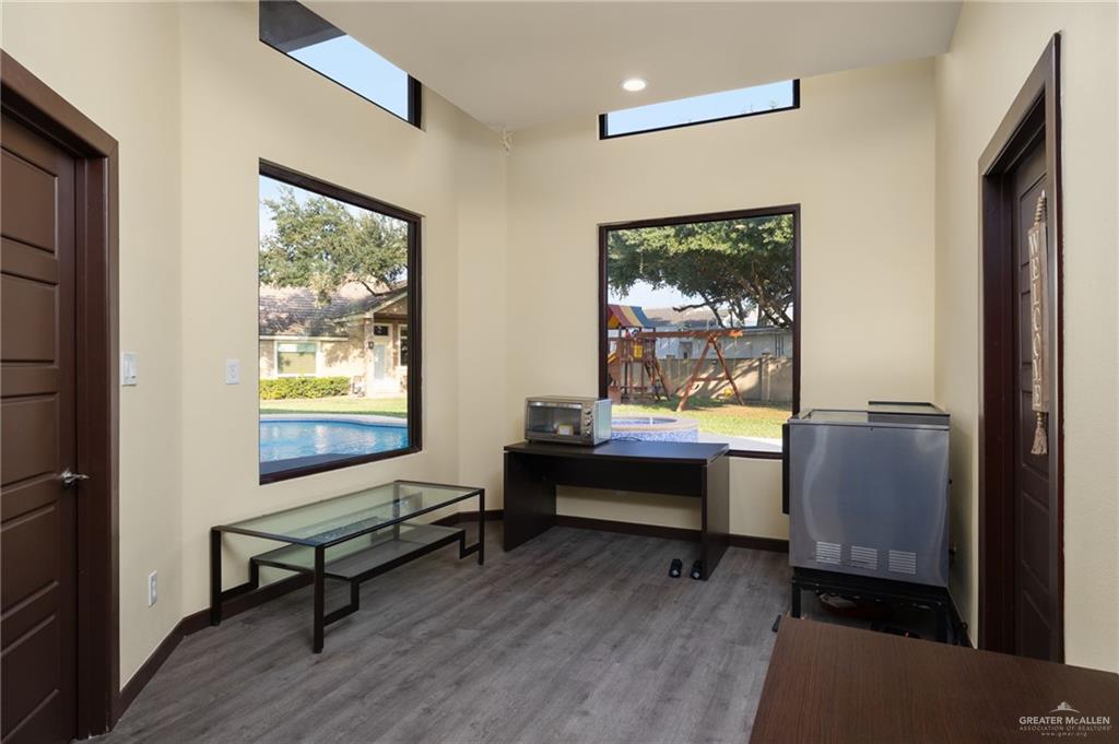 809 Rio Grande Drive Mission, TX 78572 - Photo 32 of 45 a room with wooden floor pool table and windows