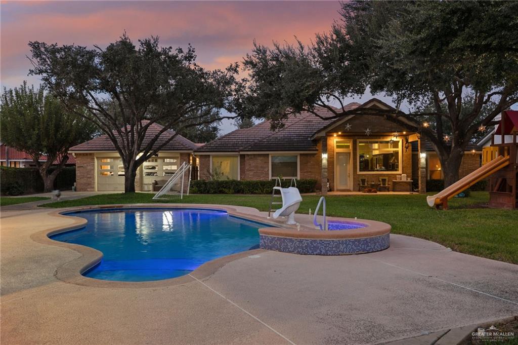 809 Rio Grande Drive Mission, TX 78572 - Photo 36 of 45 a front view of a house with a yard fountain and tree