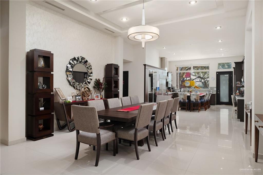 809 Rio Grande Drive Mission, TX 78572 - Photo 10 of 45 a view of a dining room with furniture and chandelier