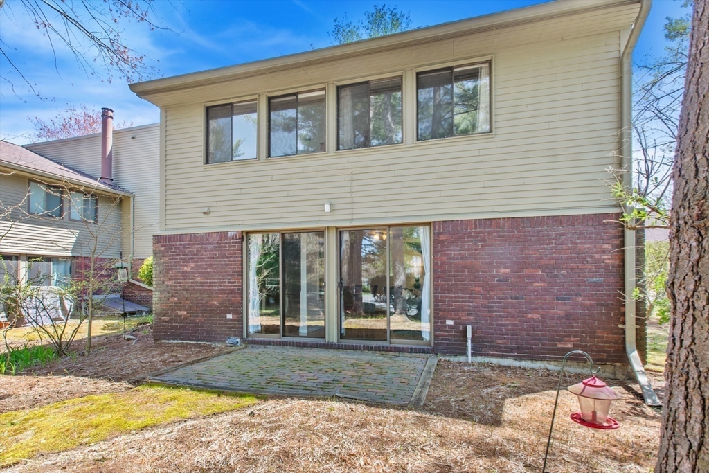 a view of a brick house with many windows