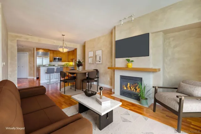 a living room with furniture fireplace and flat screen tv