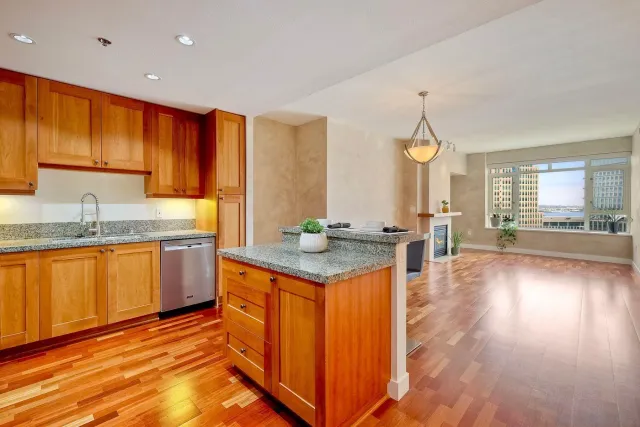 a kitchen with stainless steel appliances granite countertop a sink stove and cabinets
