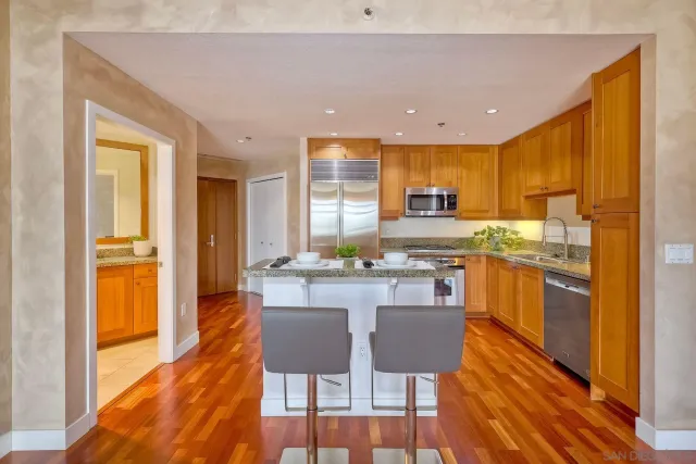 a kitchen with a sink cabinets and wooden floor
