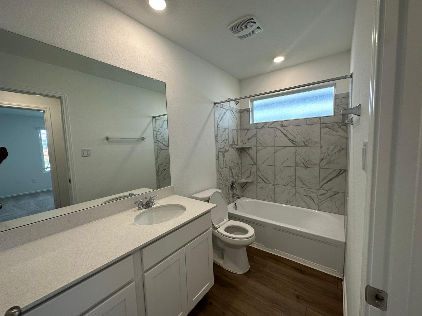1594 Marley Kyle, TX 78640 - Photo 14 of 34 a bathroom with a bathtub shower sink mirror and toilet