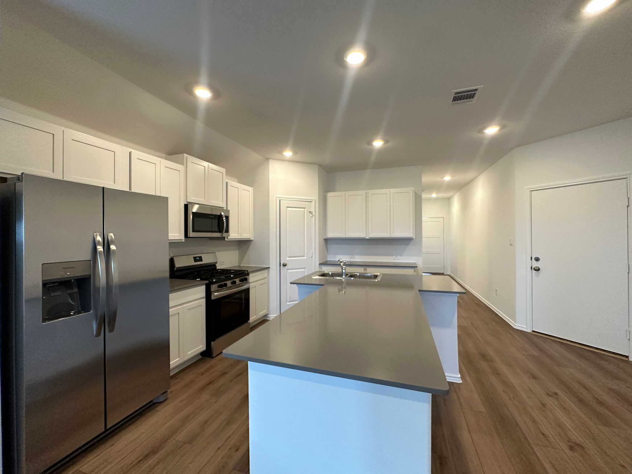 1594 Marley Kyle, TX 78640 - Photo 18 of 34 a kitchen with stainless steel appliances a refrigerator sink and microwave
