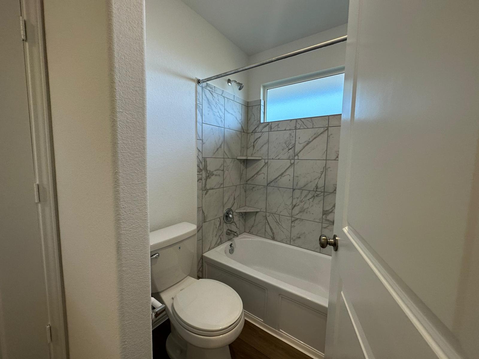 1594 Marley Kyle, TX 78640 - Photo 23 of 34 a bathroom with a toilet and a bathtub