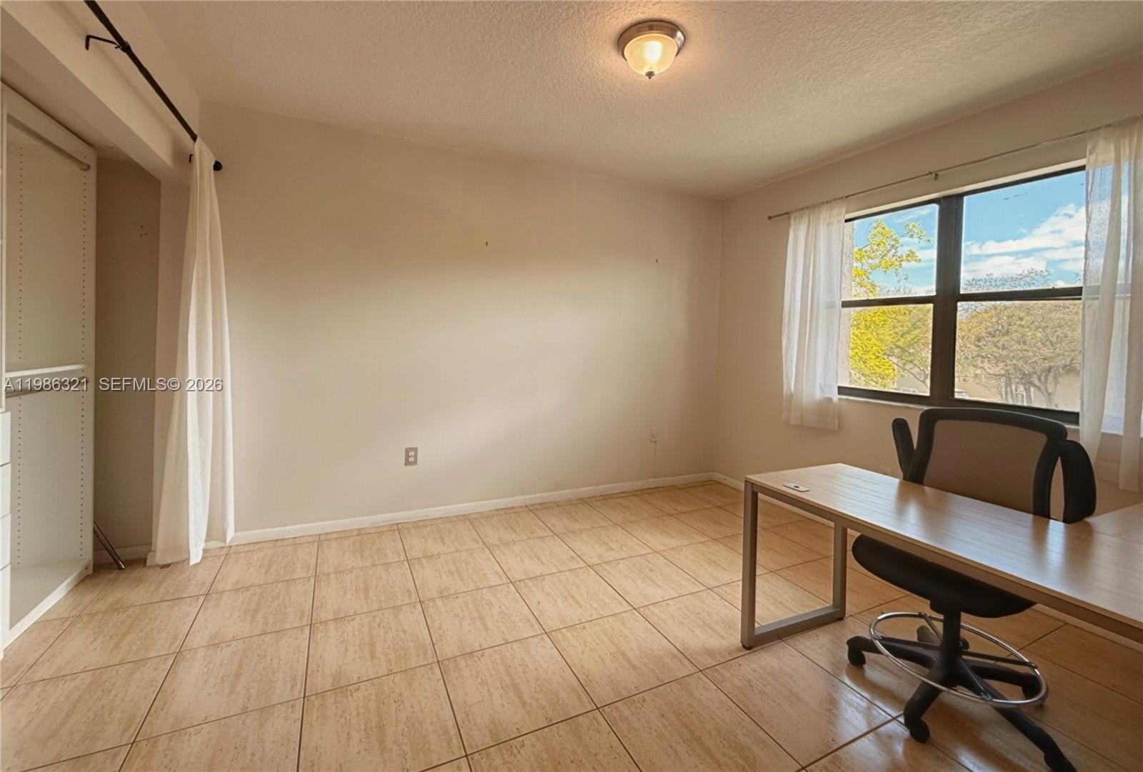 511 Ives Dairy Road, Unit 3016 Miami, FL 33179 - Photo 14 of 72 a view of a workspace with a window