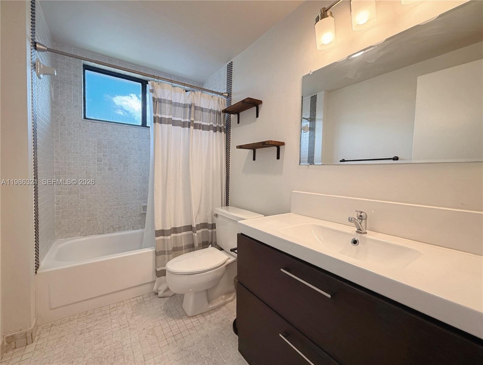 511 Ives Dairy Road, Unit 3016 Miami, FL 33179 - Photo 16 of 72 a bathroom with a sink a toilet and shower