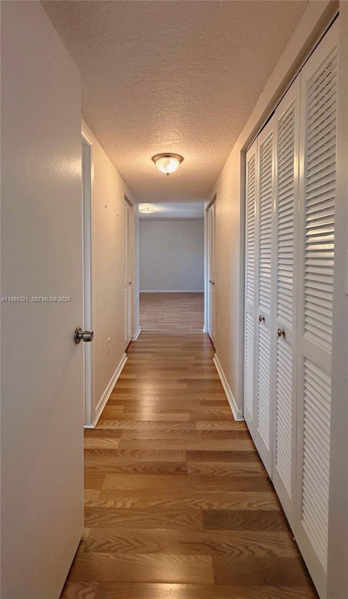 511 Ives Dairy Road, Unit 3016 Miami, FL 33179 - Photo 17 of 72 a view of a hallway with wooden floor and staircase