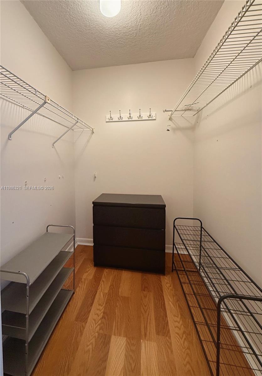 511 Ives Dairy Road, Unit 3016 Miami, FL 33179 - Photo 20 of 72 a view of a room with racks on the wall