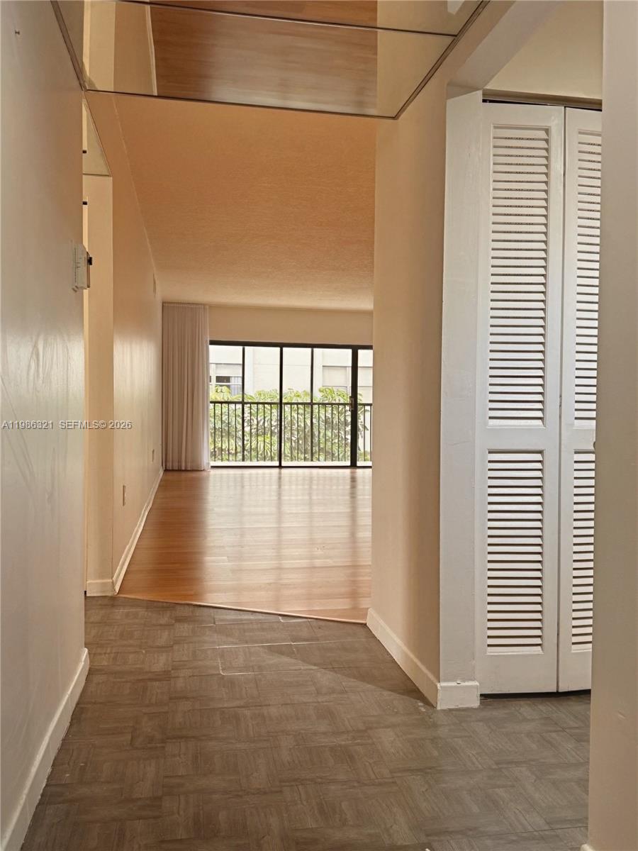 511 Ives Dairy Road, Unit 3016 Miami, FL 33179 - Photo 2 of 72 a view of a hallway with wooden floor and a window