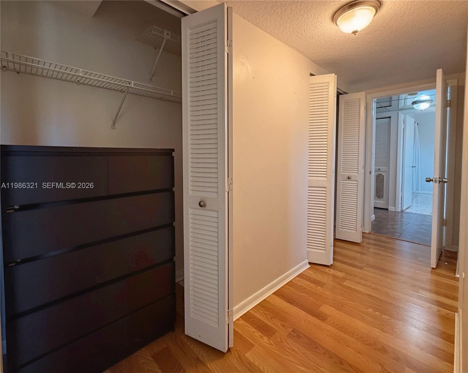 511 Ives Dairy Road, Unit 3016 Miami, FL 33179 - Photo 21 of 72 a view of a hallway with wooden floor