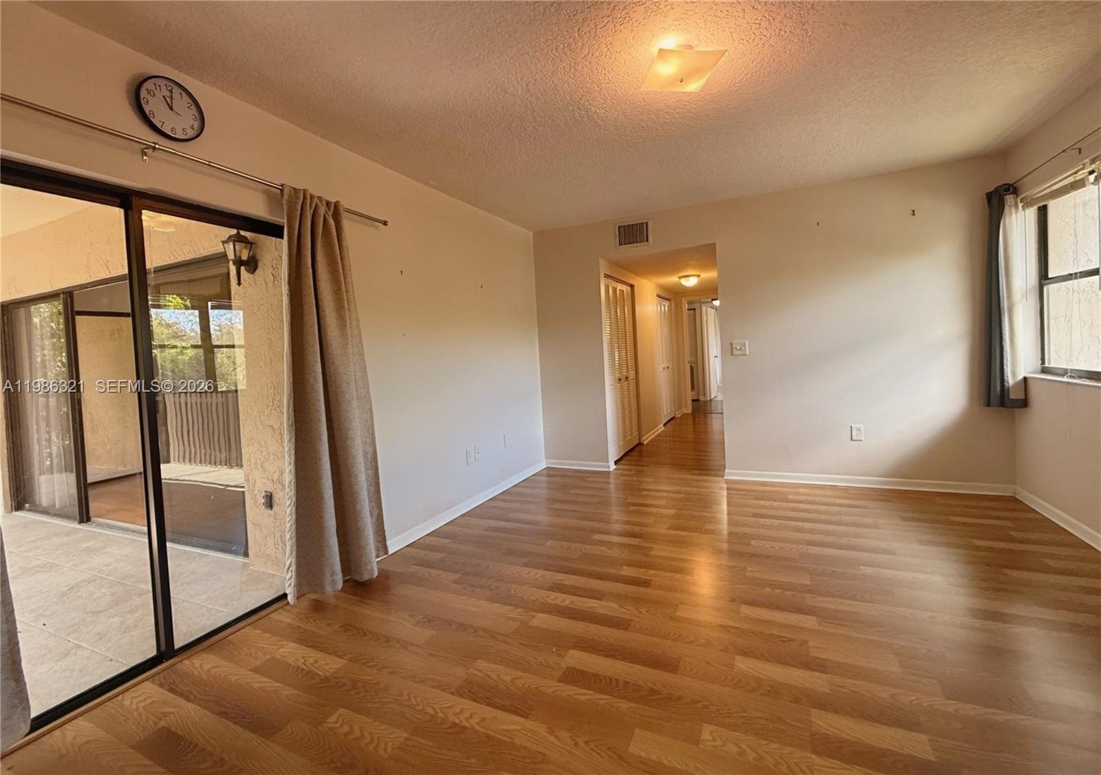 511 Ives Dairy Road, Unit 3016 Miami, FL 33179 - Photo 22 of 72 a view of empty room with wooden floor and fan