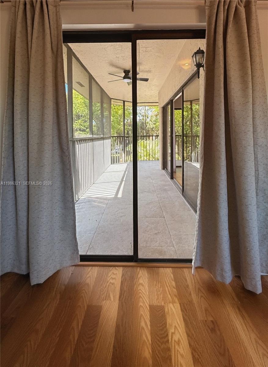 511 Ives Dairy Road, Unit 3016 Miami, FL 33179 - Photo 25 of 72 a view of an empty room with wooden floor and a window