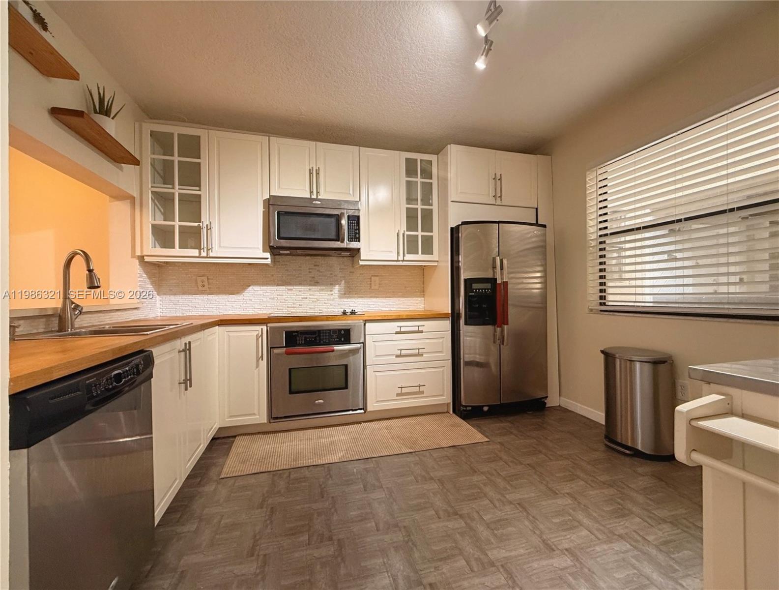 511 Ives Dairy Road, Unit 3016 Miami, FL 33179 - Photo 3 of 72 a kitchen with stainless steel appliances granite countertop a stove a sink and a refrigerator