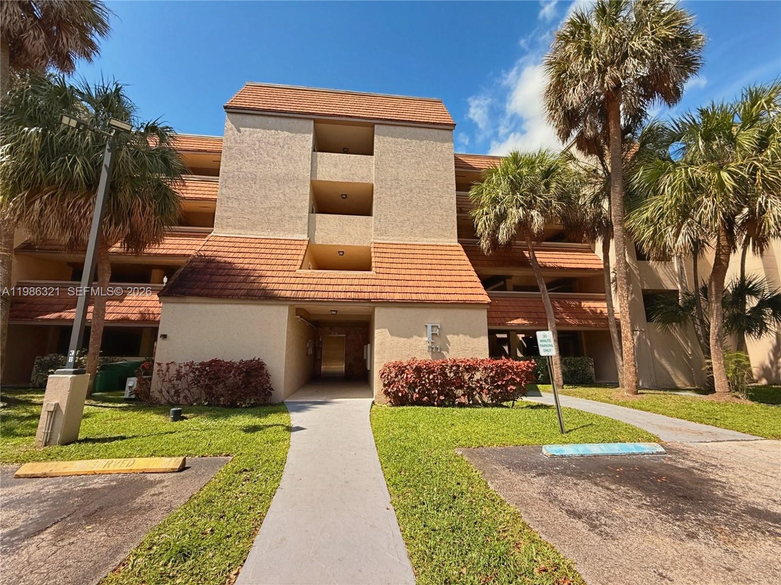 511 Ives Dairy Road, Unit 3016 Miami, FL 33179 - Photo 39 of 72 a front view of a house with a yard