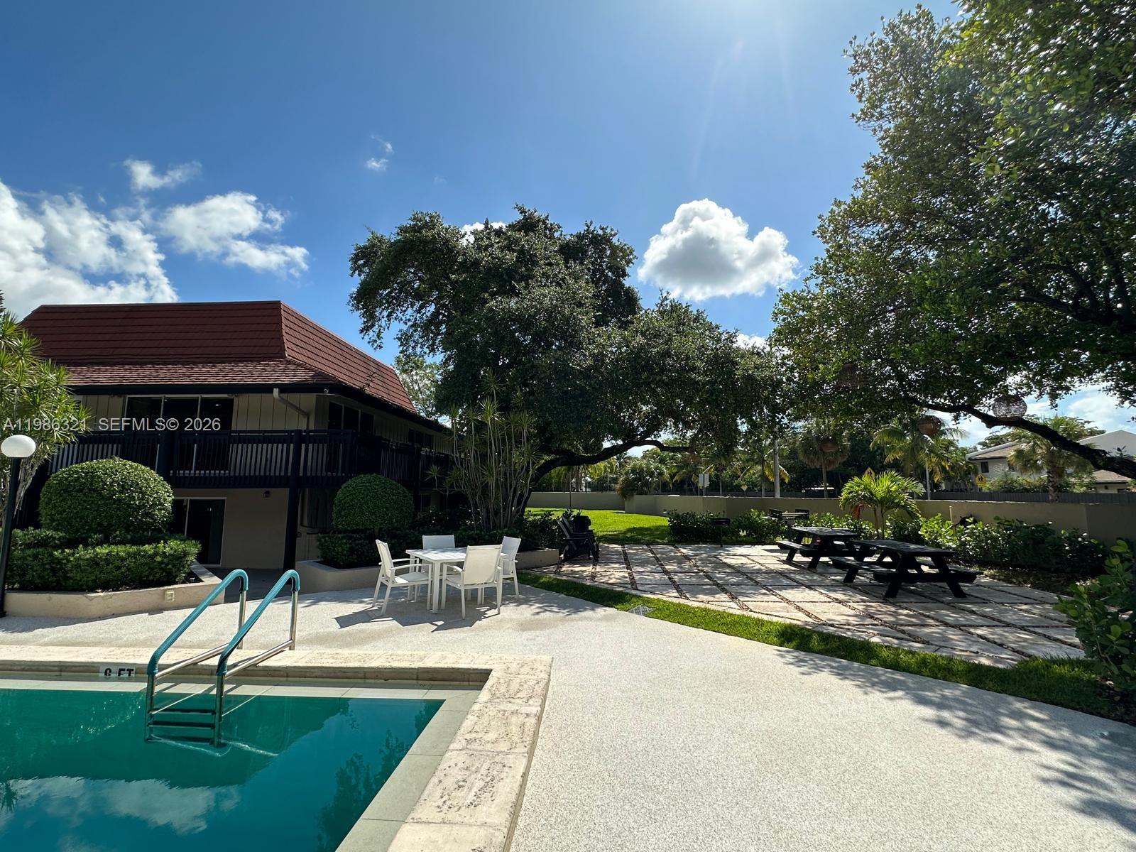 511 Ives Dairy Road, Unit 3016 Miami, FL 33179 - Photo 53 of 72 a view of a house with backyard porch and sitting area