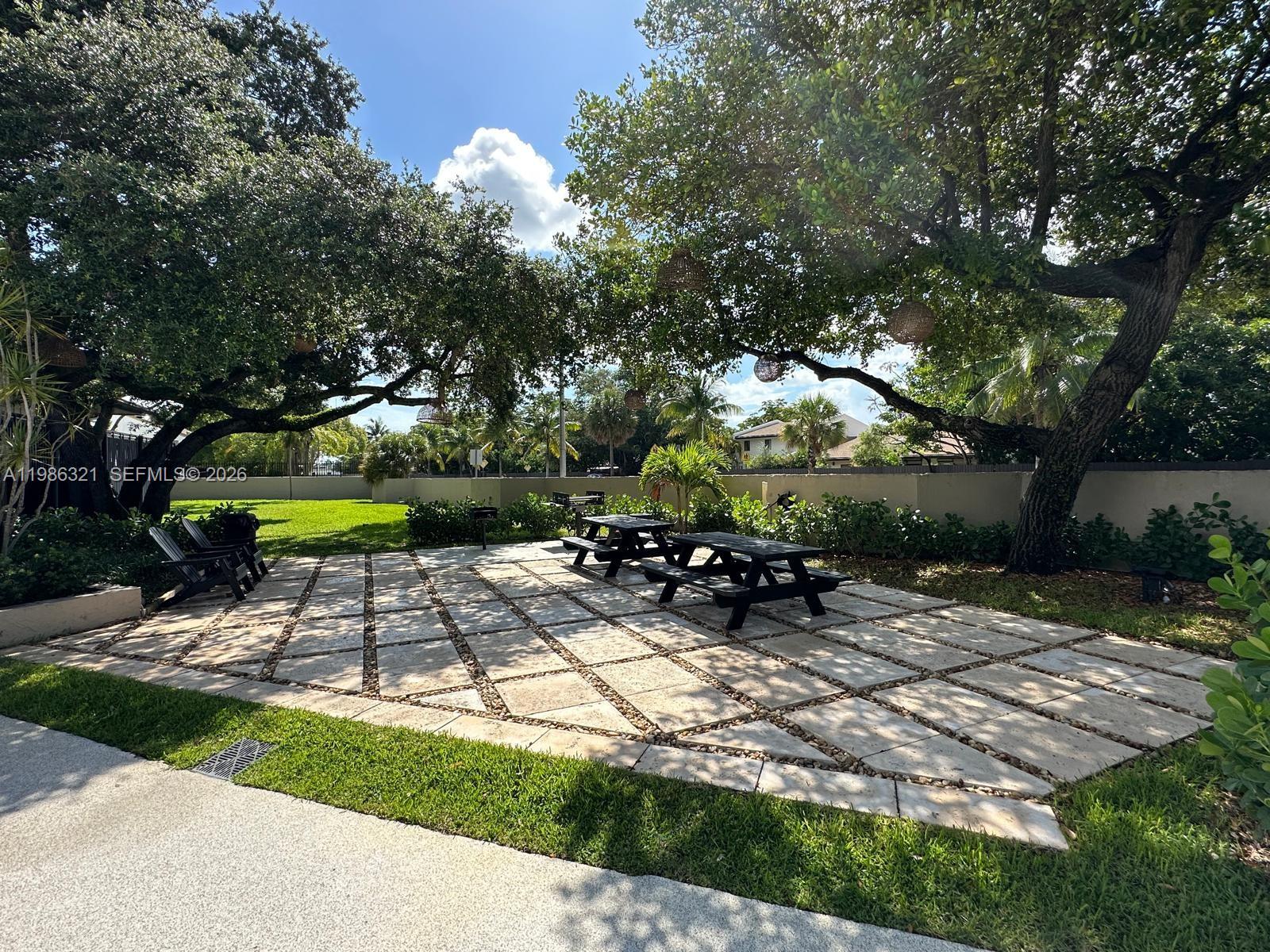 511 Ives Dairy Road, Unit 3016 Miami, FL 33179 - Photo 56 of 72 a view of a bench in a backyard