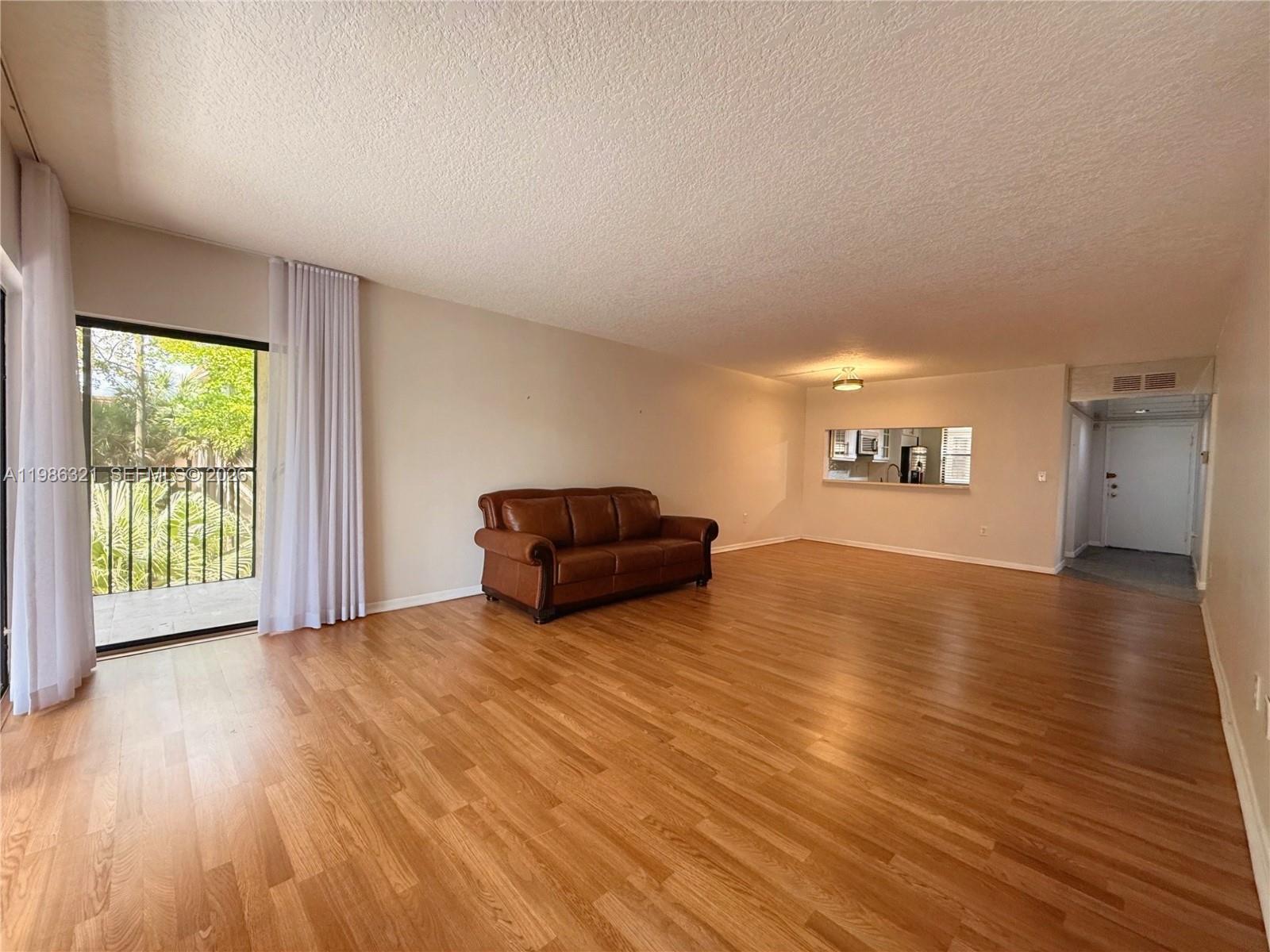 511 Ives Dairy Road, Unit 3016 Miami, FL 33179 - Photo 7 of 72 a living room with furniture and a wooden floor