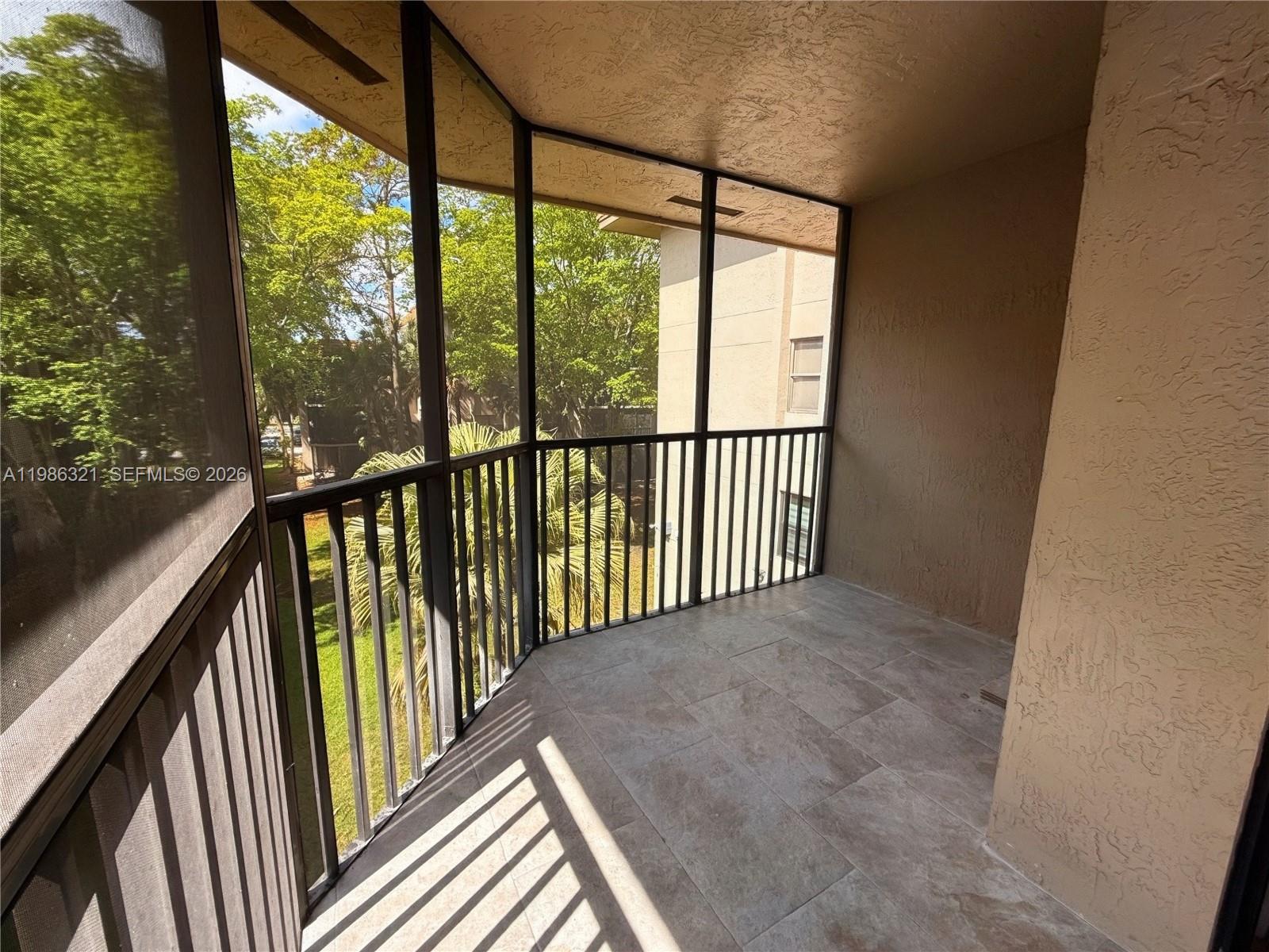 511 Ives Dairy Road, Unit 3016 Miami, FL 33179 - Photo 10 of 72 a view of a balcony with wooden floor