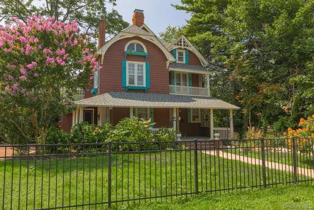 a front view of a house with a garden and plants