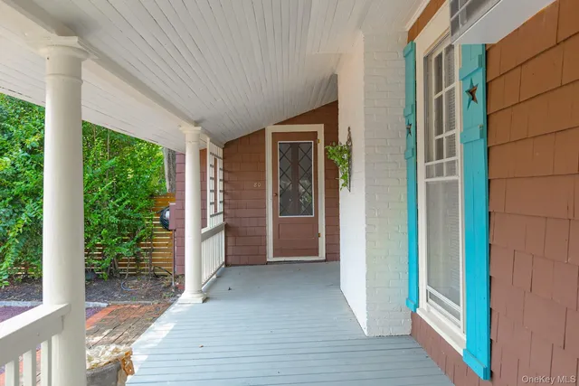 a view of front door and porch with wooden floor