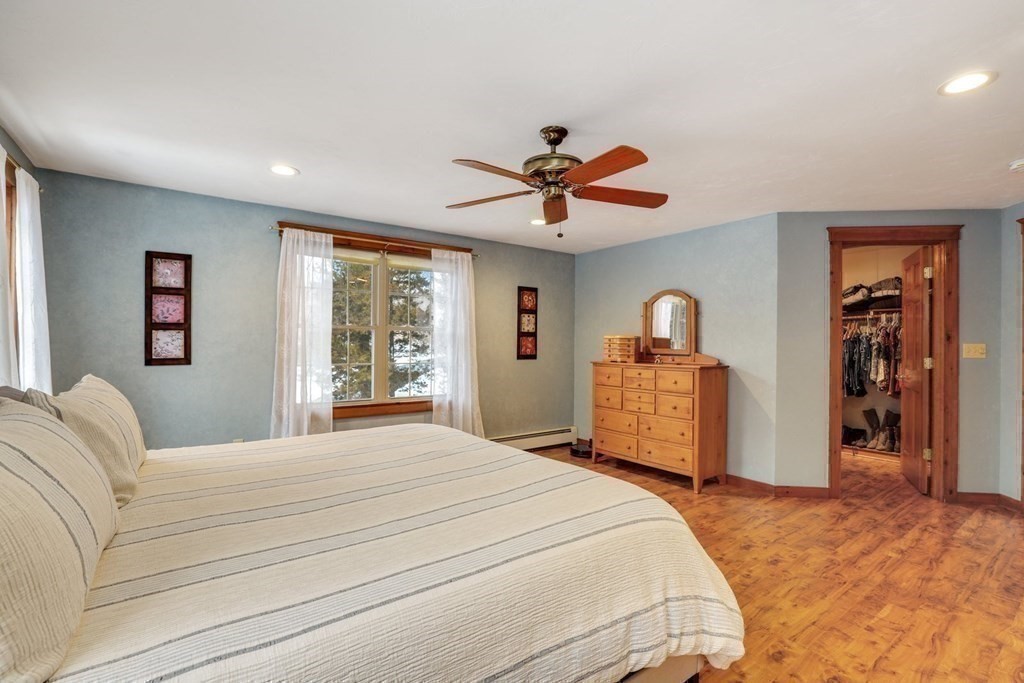 70 R Milk Street Blackstone, MA 01504 - Photo 20 of 40 a bedroom with a large bed and a chandelier