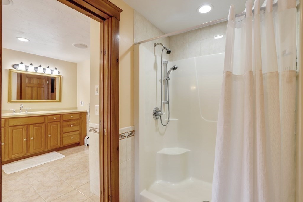 70 R Milk Street Blackstone, MA 01504 - Photo 23 of 40 a spacious bathroom with a shower a sink and a mirror