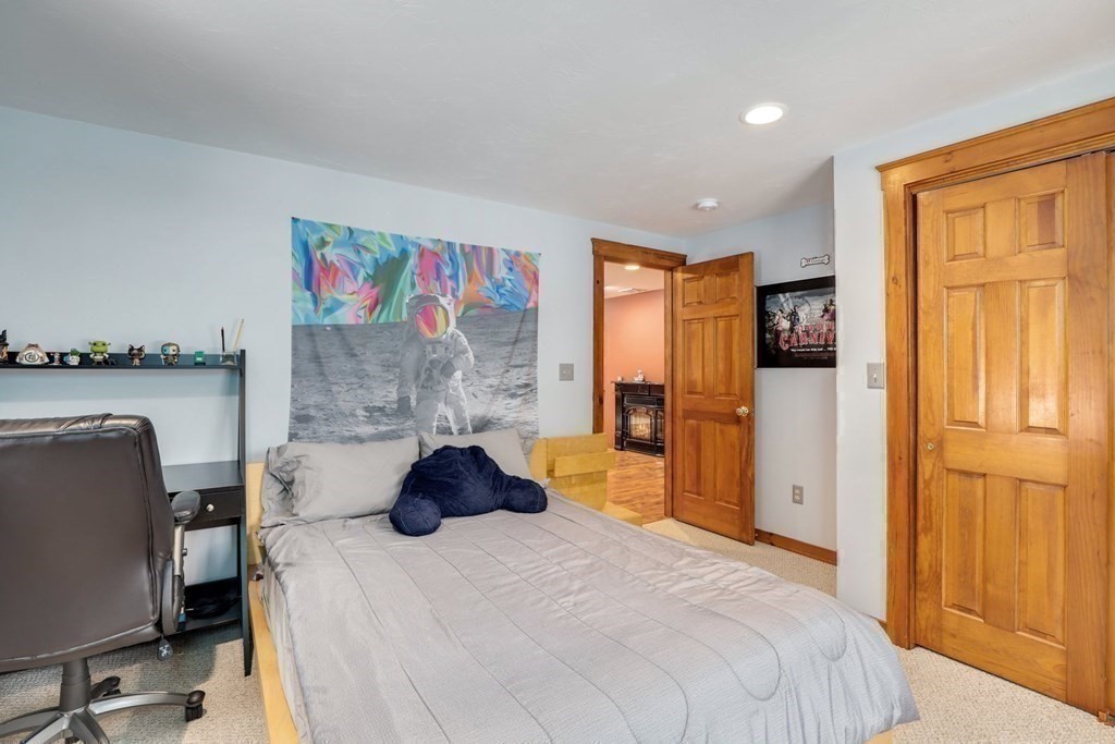 70 R Milk Street Blackstone, MA 01504 - Photo 25 of 40 a bedroom with a bed and wooden floor