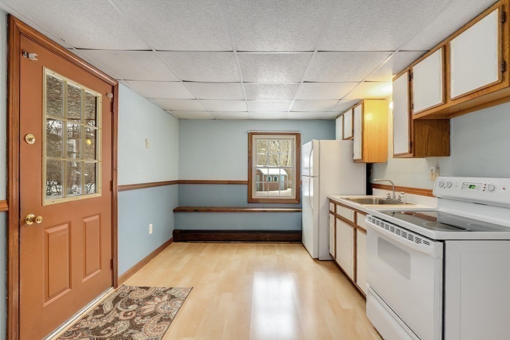 70 R Milk Street Blackstone, MA 01504 - Photo 30 of 40 a kitchen with stainless steel appliances granite countertop a stove and a refrigerator