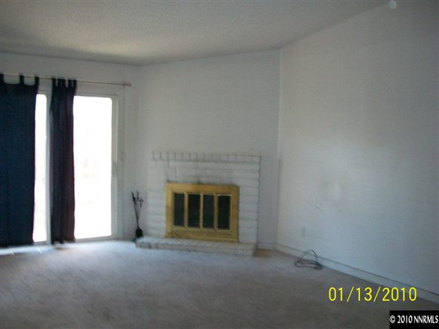 15024 Humite Lane Reno, NV 89506 - Photo 2 of 8 a view of empty room with a fireplace