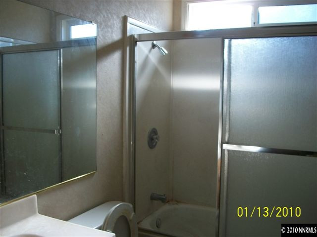 15024 Humite Lane Reno, NV 89506 - Photo 7 of 8 a bathroom with a glass shower door