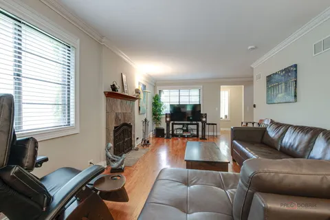 a living room with furniture flat screen tv and a fireplace