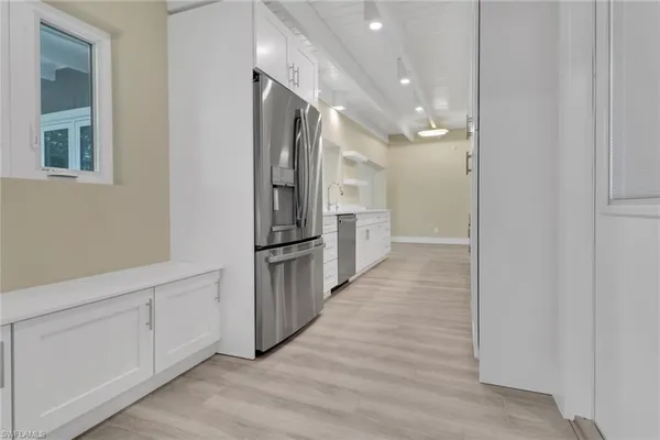 a view of a hallway with wooden floor