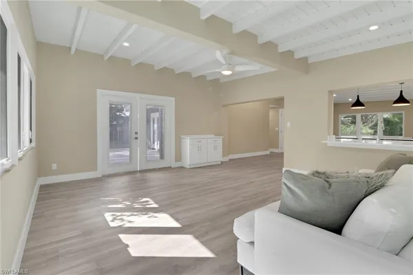 a living room with furniture and a hard wood floor