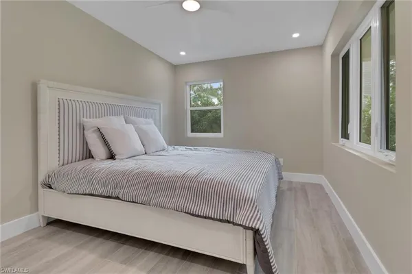 a large bed sitting in a bedroom next to a window