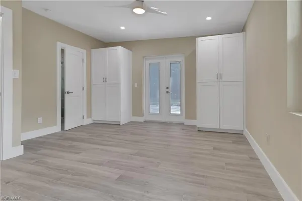 a view of an empty room with wooden floor