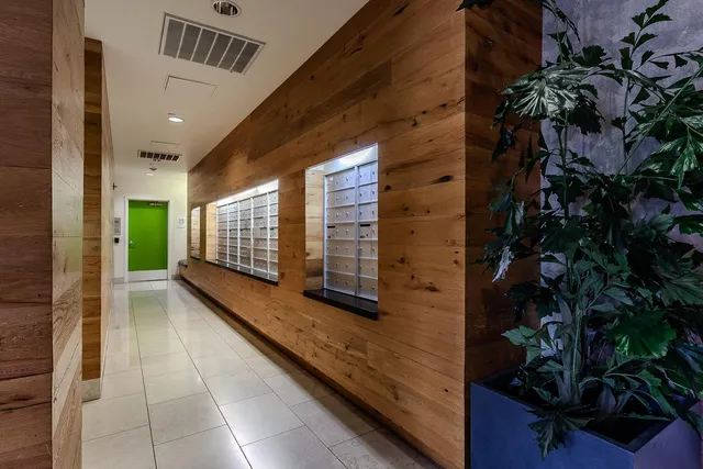a group of people sitting in front of a building with yard