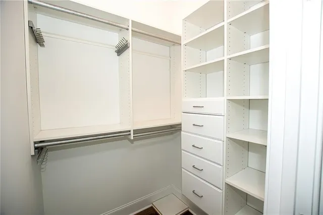 a bathroom with a granite countertop sink a toilet and a mirror