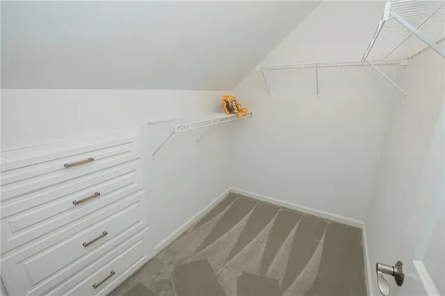 a kitchen with stainless steel appliances kitchen island granite countertop a table chairs and a refrigerator