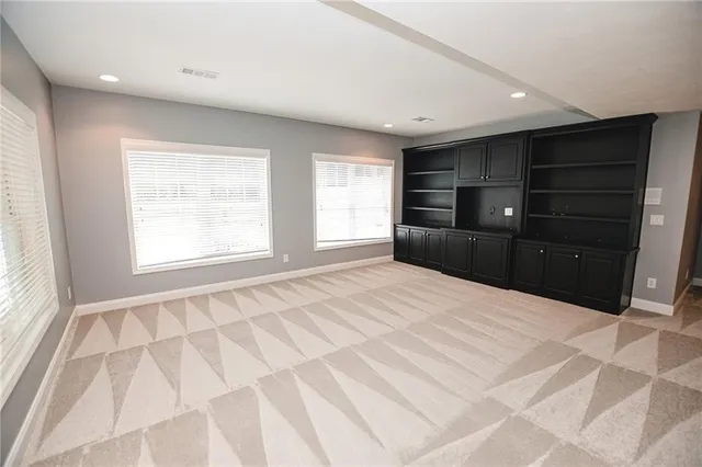 a view of a house with a yard and large trees