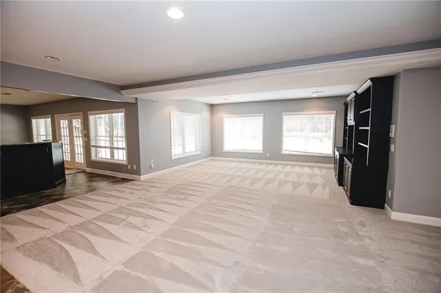 a front view of a house with a yard and trees