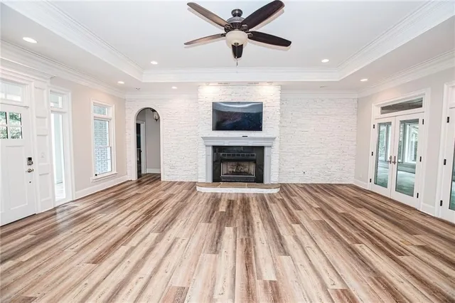 a view of livingroom window fireplace and wooden floor