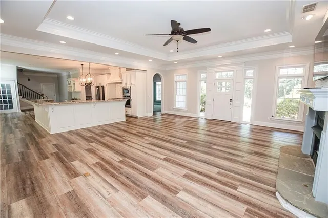 a view of a bedroom with wooden floor and stairs
