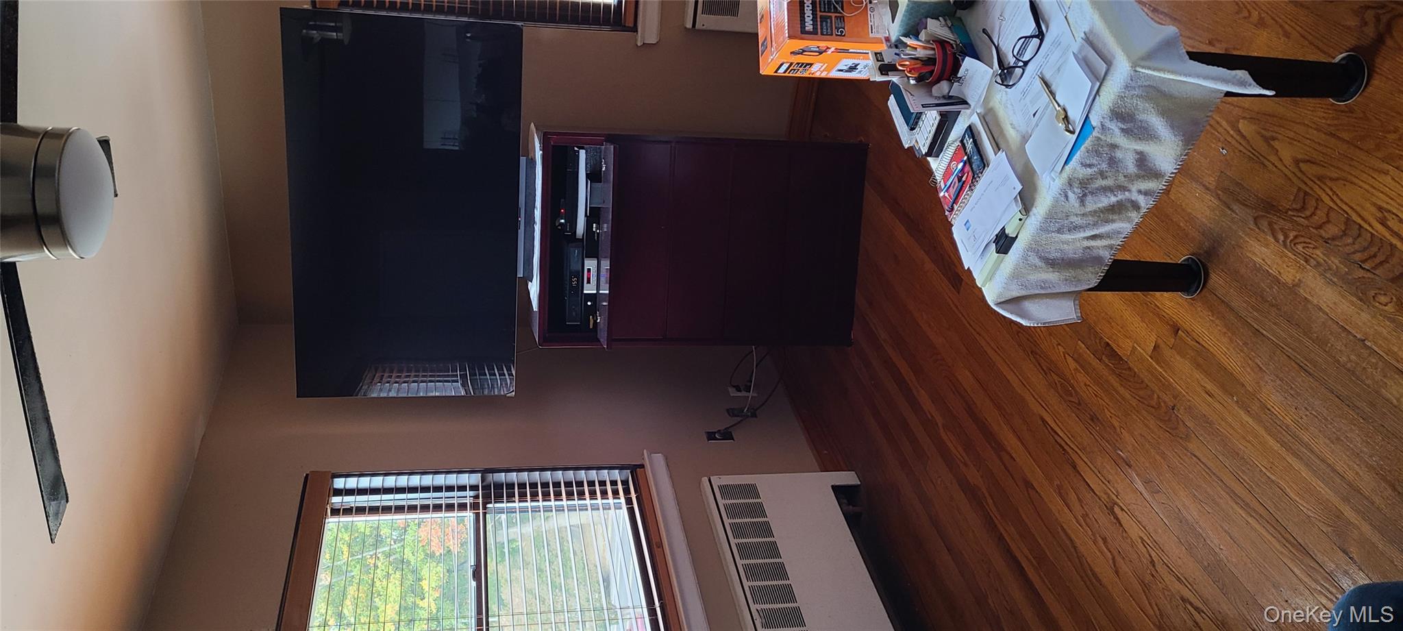 73-54 Springfield Boulevard, Unit 54A2 Queens, NY 11364 - Photo 2 of 11 a bedroom with a bed and wooden floor