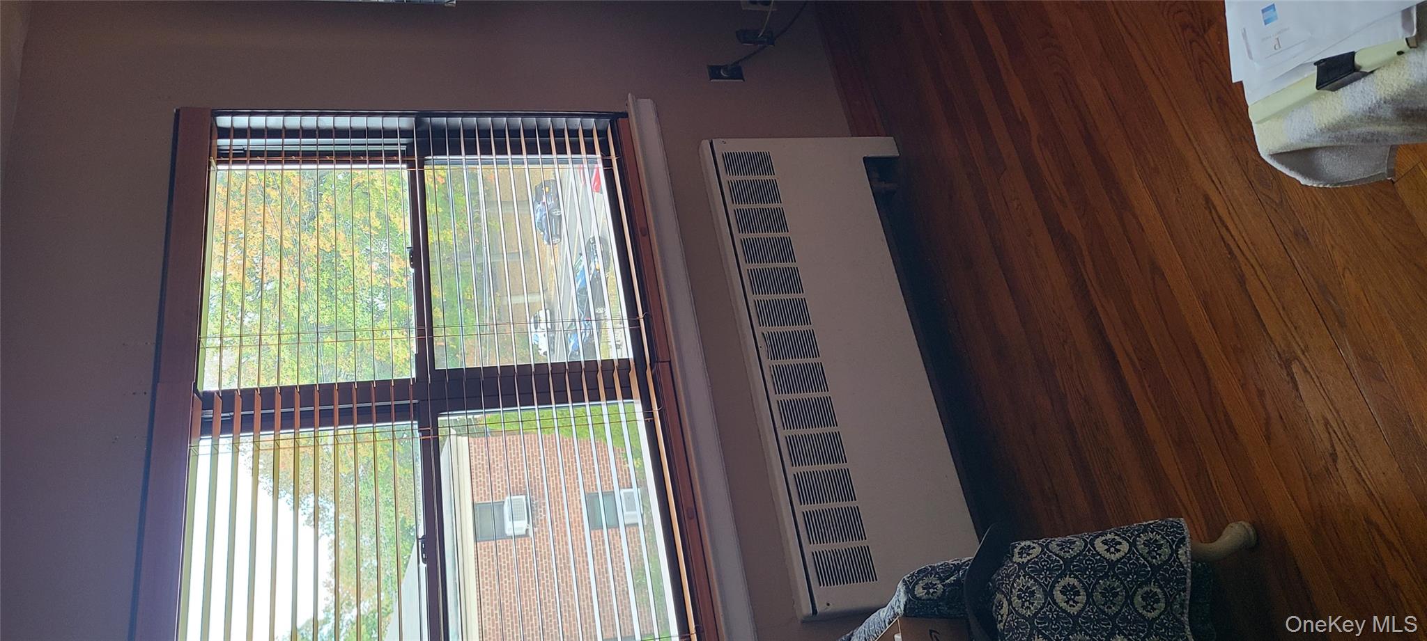 73-54 Springfield Boulevard, Unit 54A2 Queens, NY 11364 - Photo 3 of 11 a view of a room with wooden floor and a window