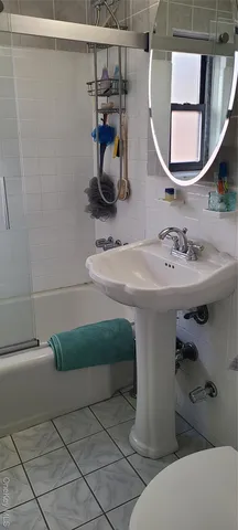 a bathroom with a sink mirror and toilet