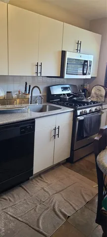 a kitchen with stainless steel appliances granite countertop a sink and a stove