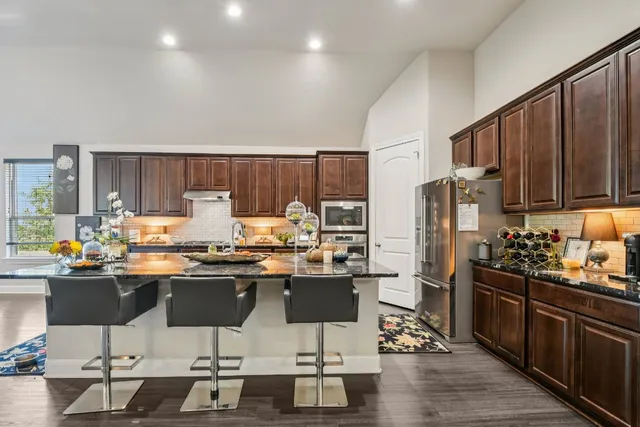 a kitchen with a table chairs stove and cabinets